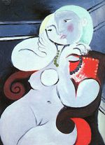 Female nude sitting in red armchair